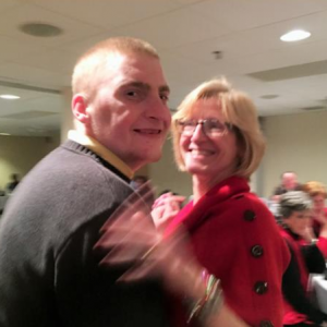 Adult resident dances with his mother at event