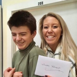 A student and teacher smiling in the Schoolhouse.