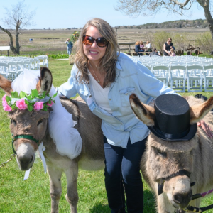 A Latham Friend takes photo with two-donkeys dressed for a "wedding."