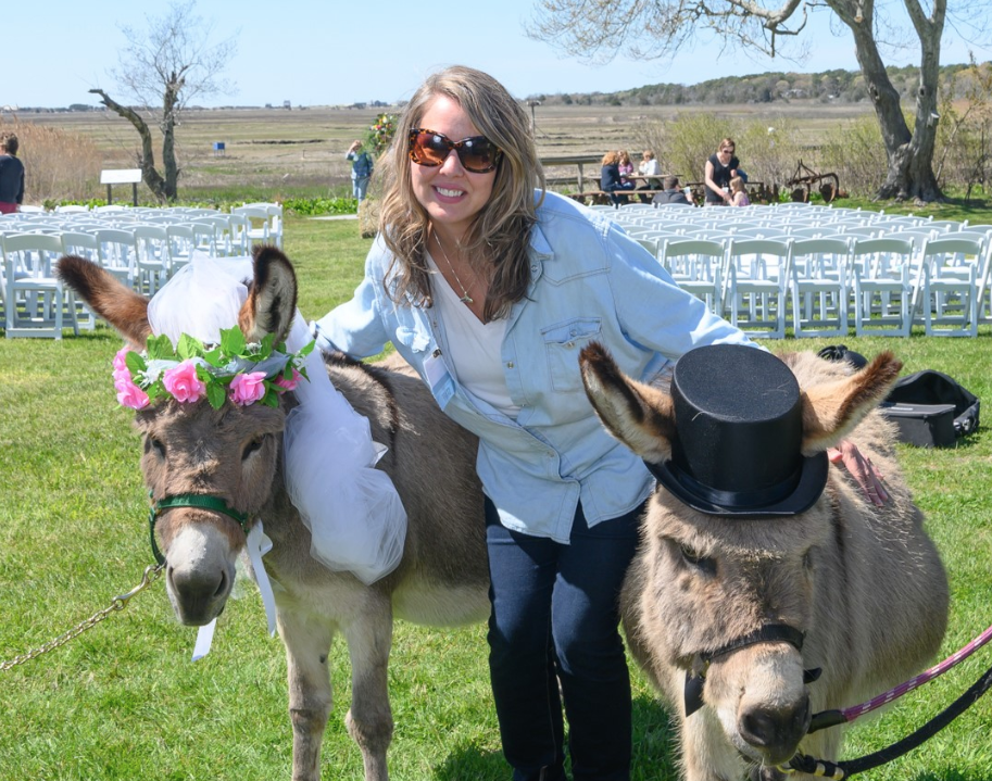 A Latham Friend takes photo with two-donkeys dressed for a "wedding."