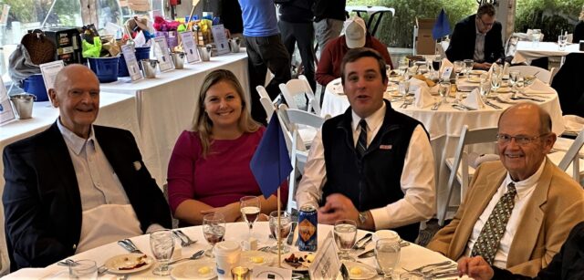 A group enjoying dinner at a fundraiser.