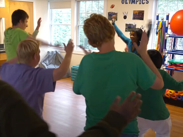 Students dance for a physical fitness activity in P.E.