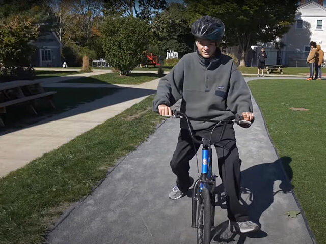 Student rides his bike on Latham Track