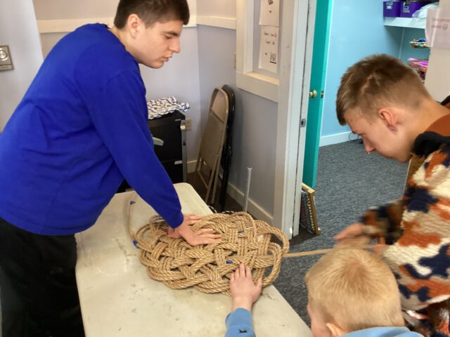 Students work in our Vocational Room weaving mats