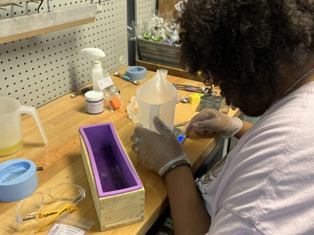 Student preparing soap for All Natural Goats Milk Soap