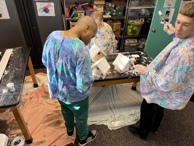 Students work in our Vocational Room making wooden bird houses