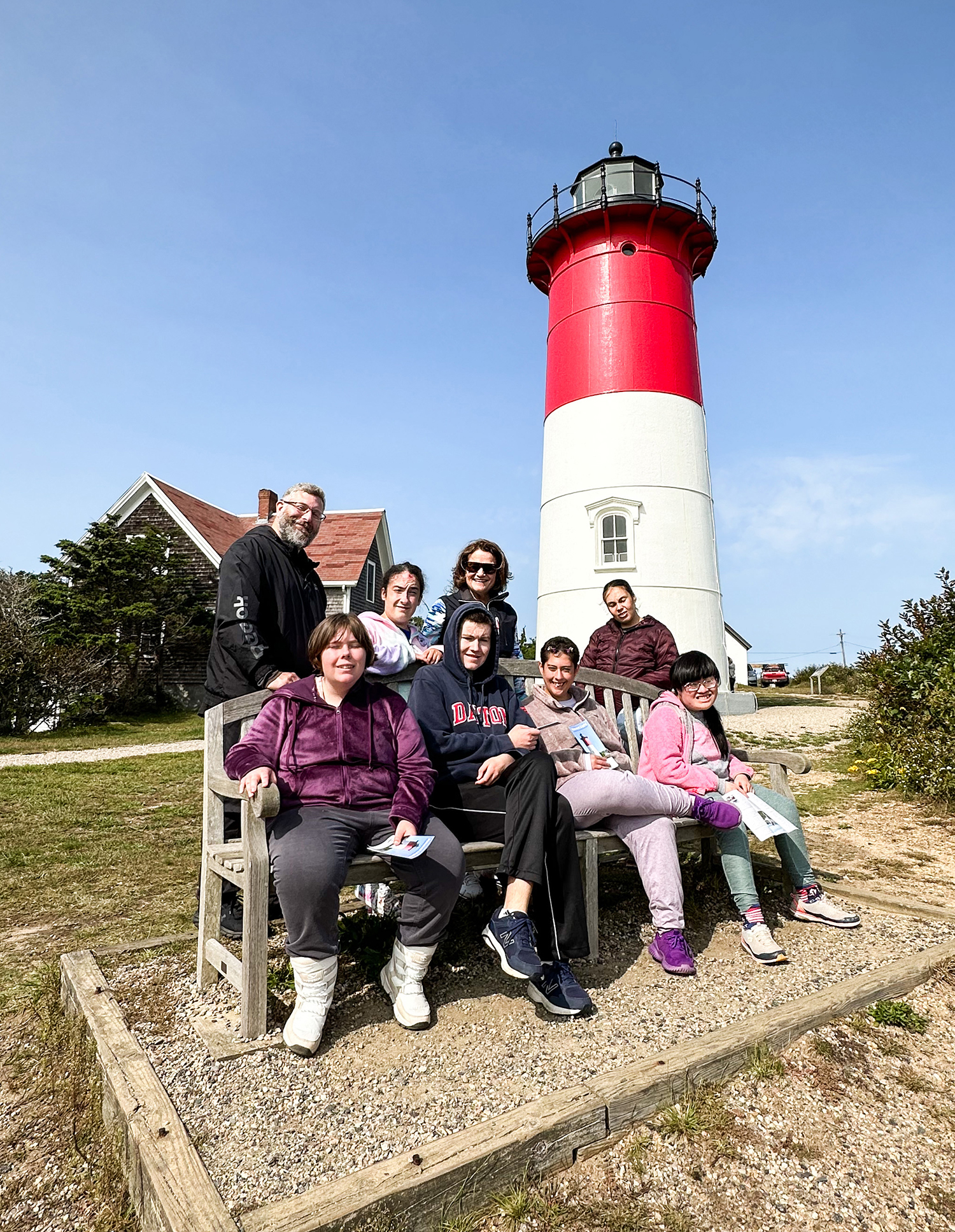 Students and Staff in front of lighthouse
