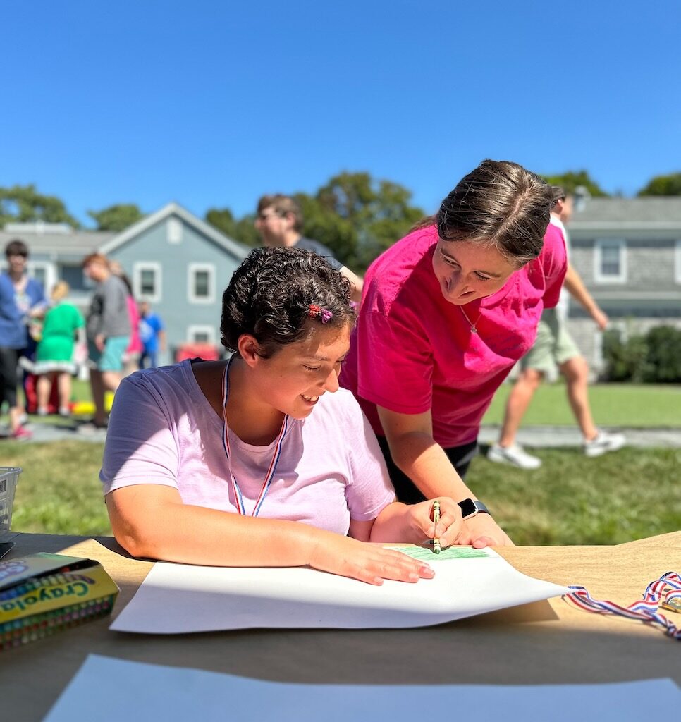 Woman Looking over shoulder of younger woman