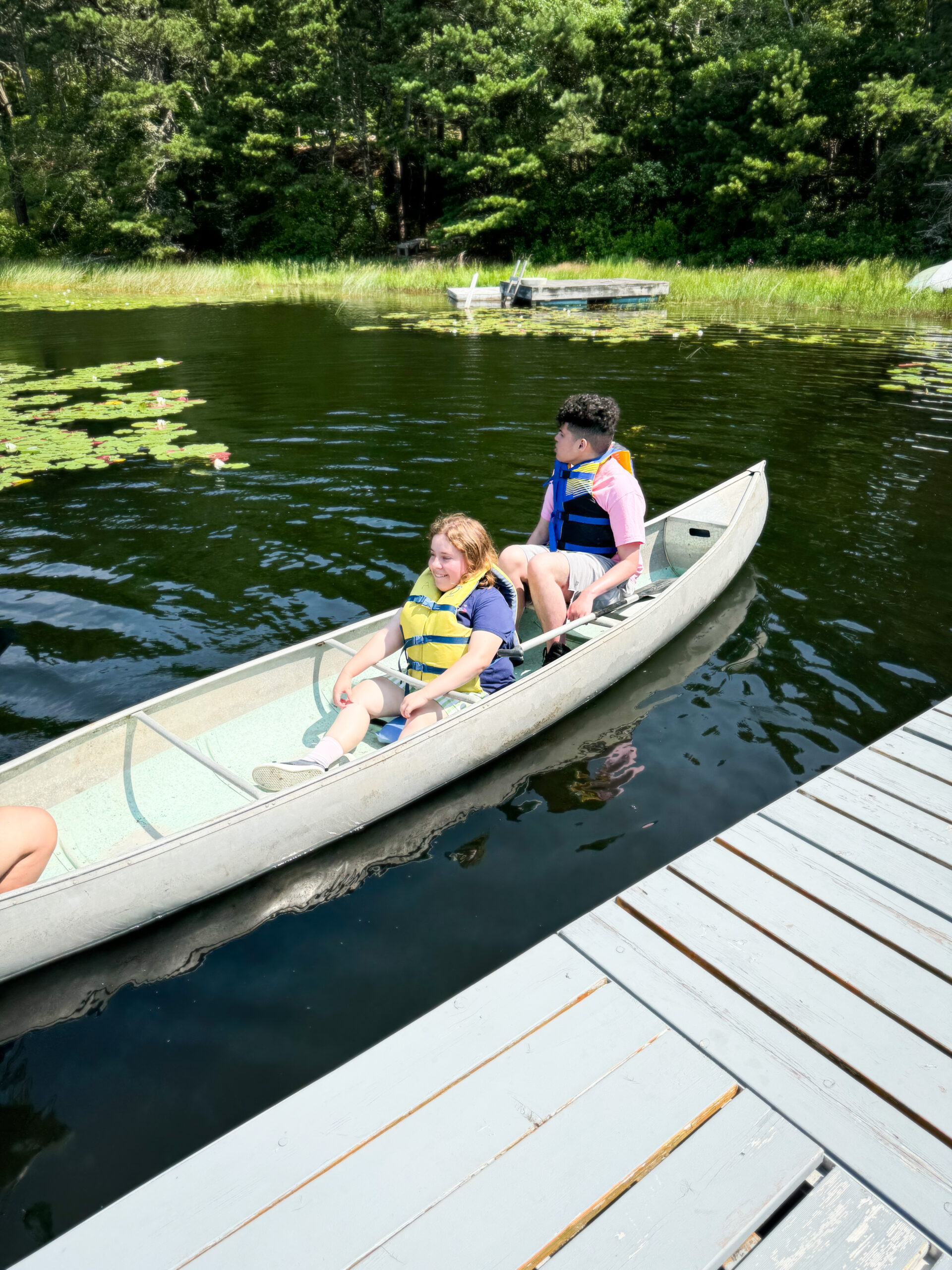 Two people in a kayak on a pond