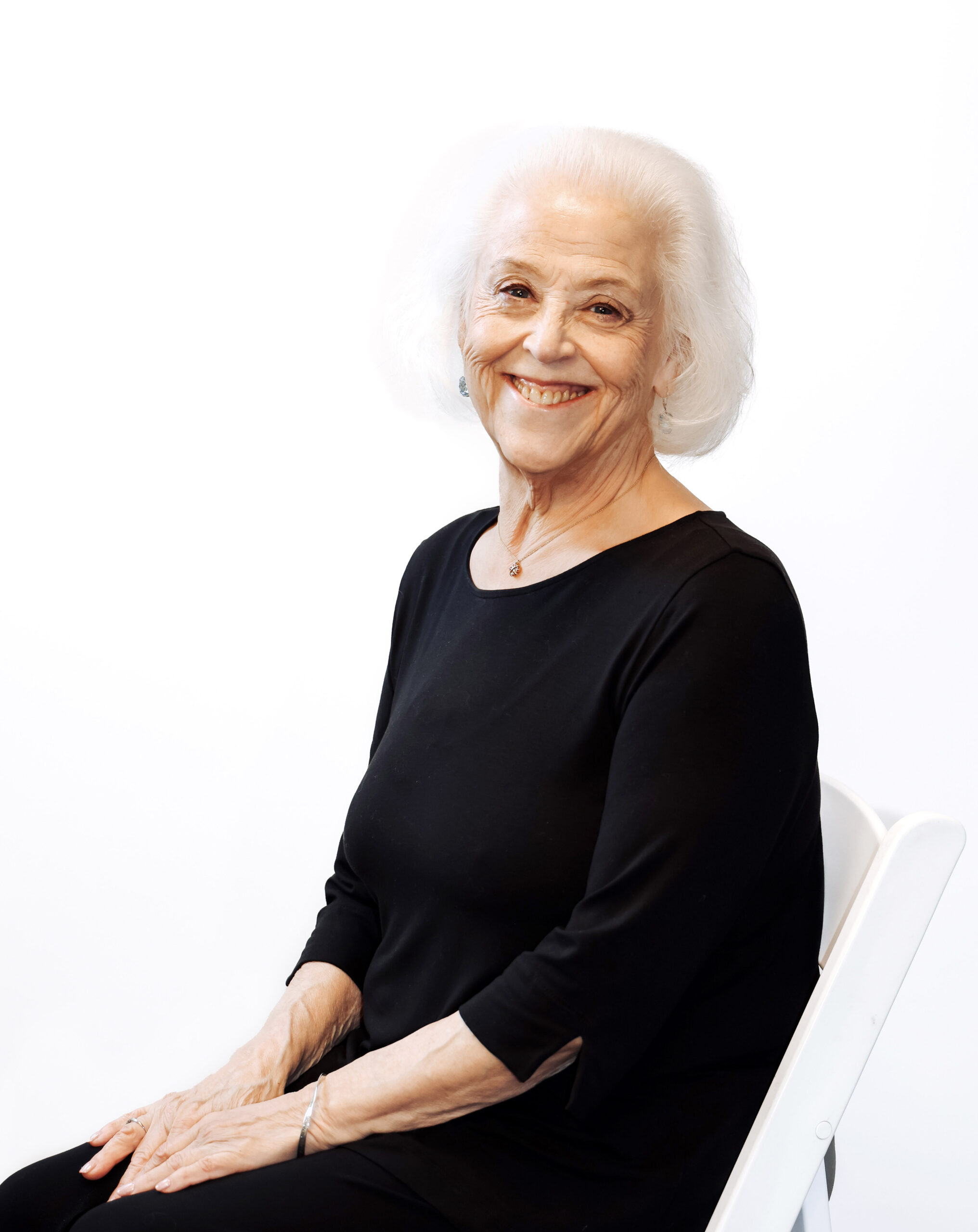 Woman in chair wearing black shirt.