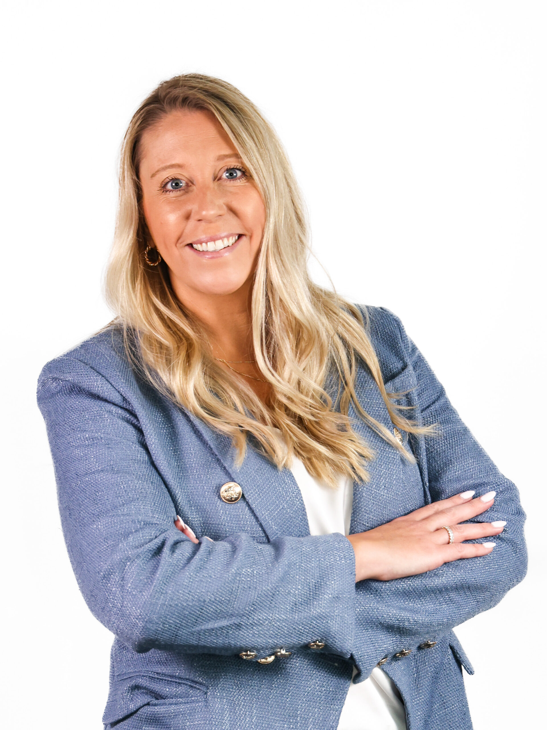 Woman with blonde hair wearing blue blazer, formal headshot